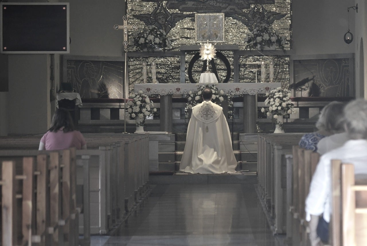 priest at adoration