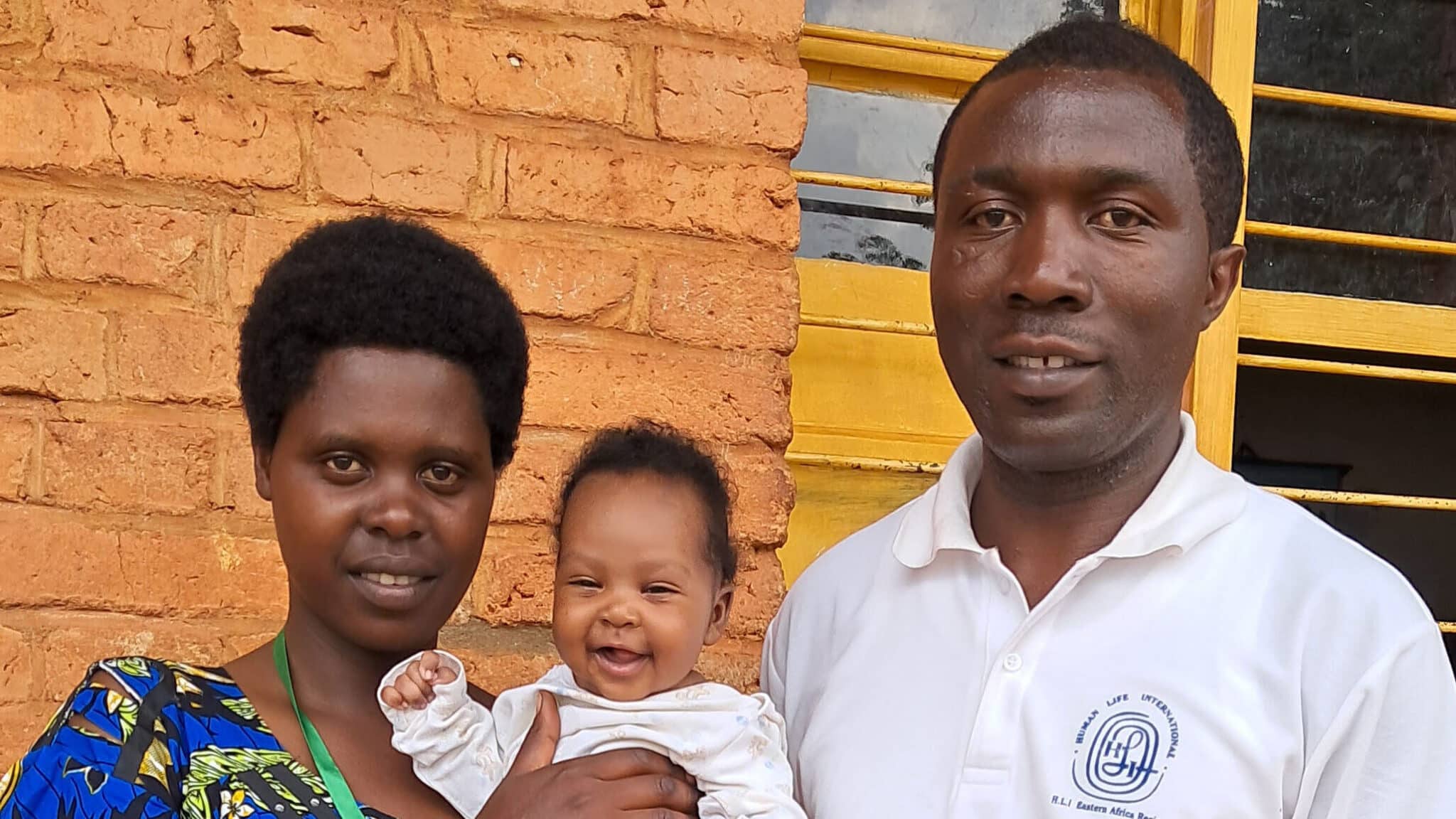 Image of an HLI missionary with a mom and child saved from abortion by donors who support the HLI Rwanda pregnancy care center