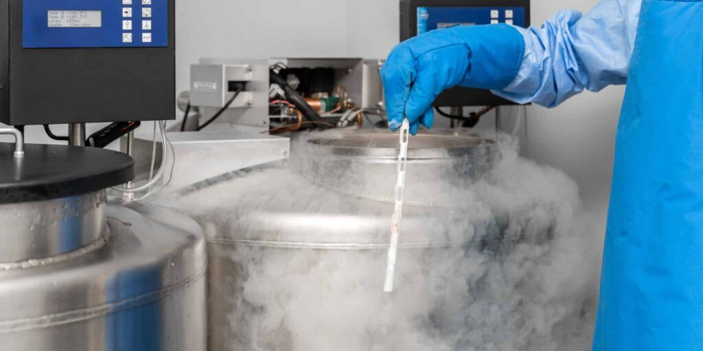 embryologist at a liquid nitrogen bank containing sperm and egg samples