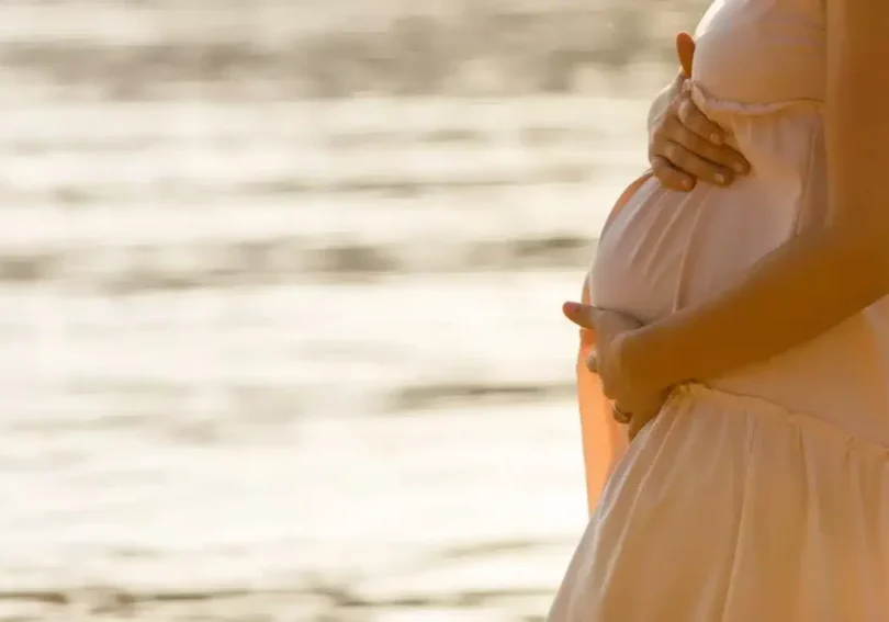 pregnant white dress by water