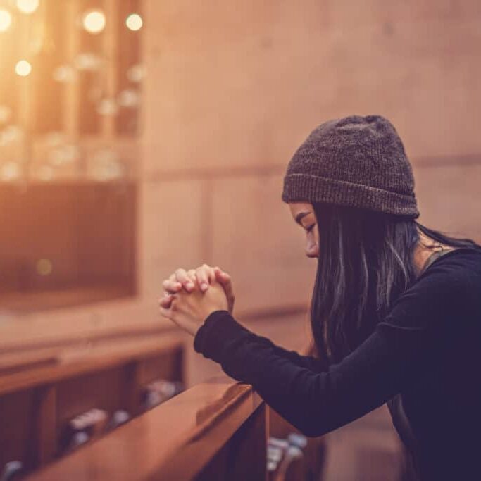 woman praying in church